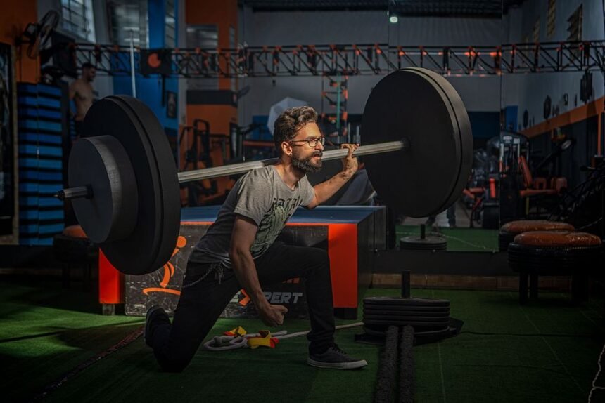 man performing barbell back squat in gym